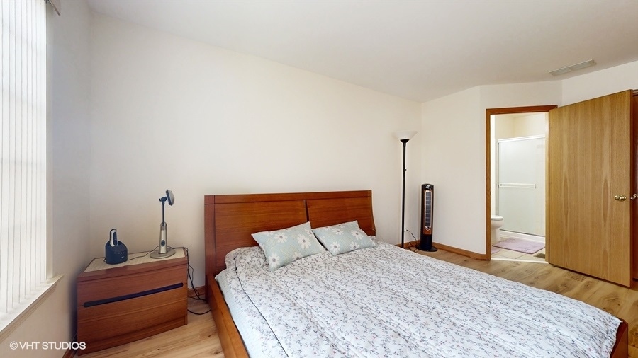 1725 Sienna Court Wheeling, IL 60090 - Photo 15 of 33 a bedroom with a bed and wooden floor