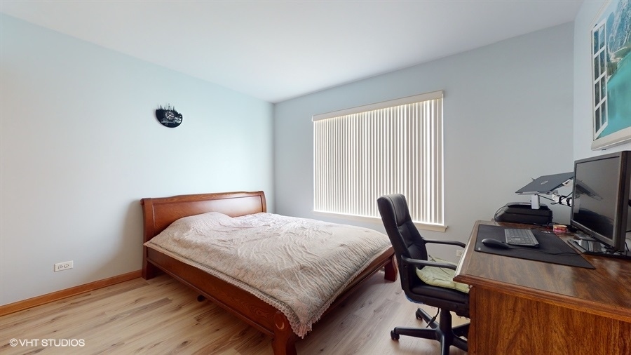1725 Sienna Court Wheeling, IL 60090 - Photo 17 of 33 a bedroom with a bed a desk and chair