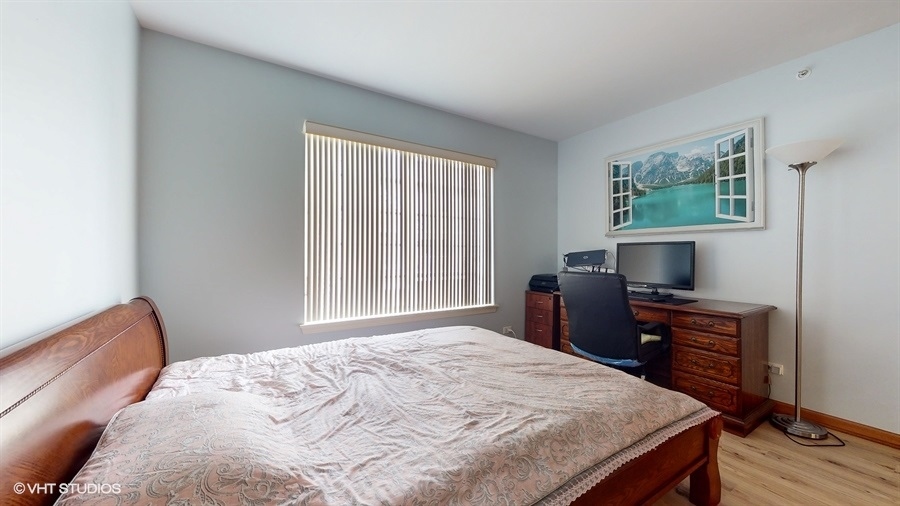 1725 Sienna Court Wheeling, IL 60090 - Photo 18 of 33 a bedroom with a bed and a flat screen tv