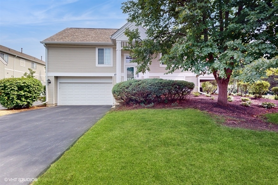 1725 Sienna Court Wheeling, IL 60090 - Photo 2 of 33 a front view of a house with a garden