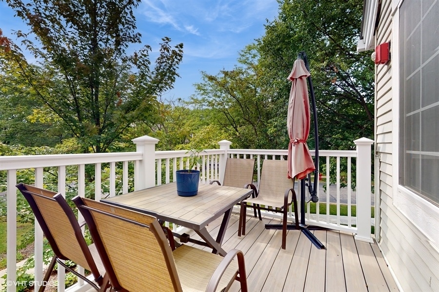 1725 Sienna Court Wheeling, IL 60090 - Photo 26 of 33 a view of a deck with two chair and wooden floor