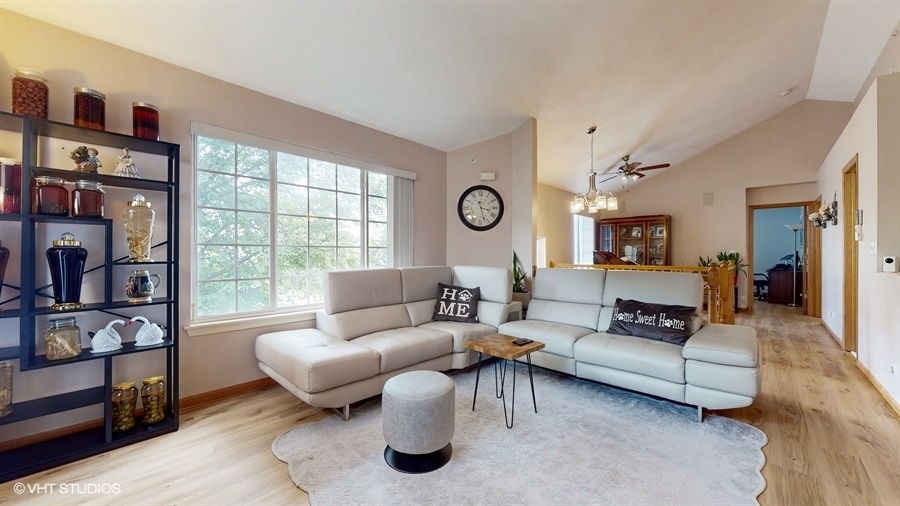 1725 Sienna Court Wheeling, IL 60090 - Photo 7 of 33 a living room with furniture and a large window