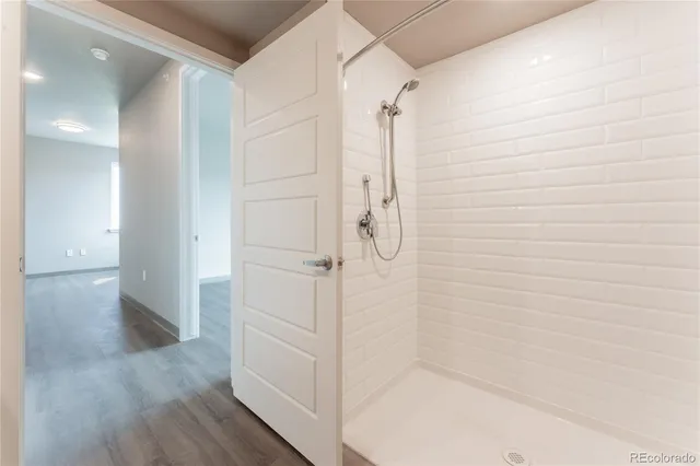 a bathroom with a shower and a glass door