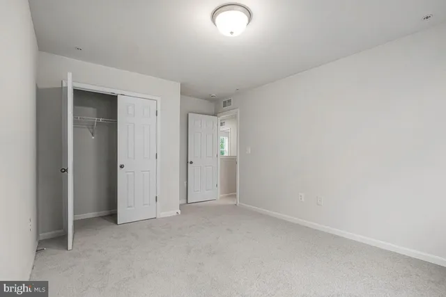 an empty room with closet area