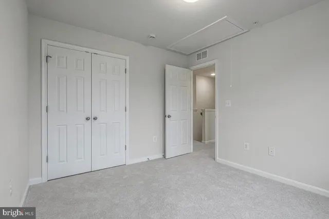 a view of an empty room and closet area
