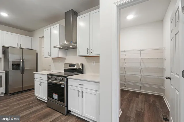 a kitchen with cabinets and stainless steel appliances