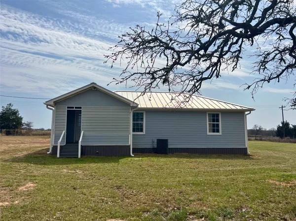 a backyard of a house with wooden deck