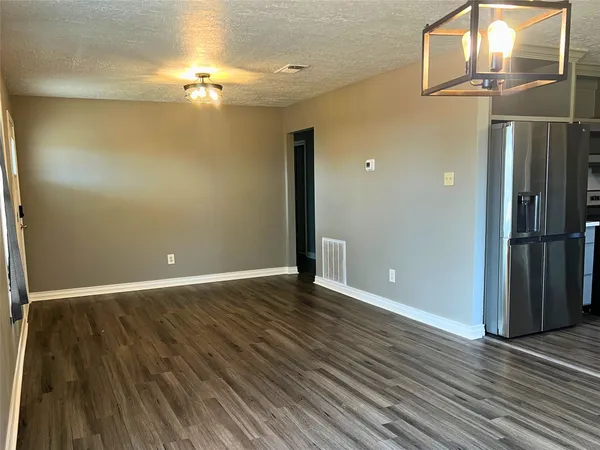 wooden floor in an empty room with a mirror