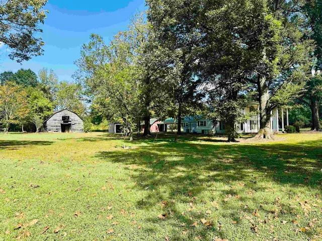 a view of a house with backyard porch and sitting area