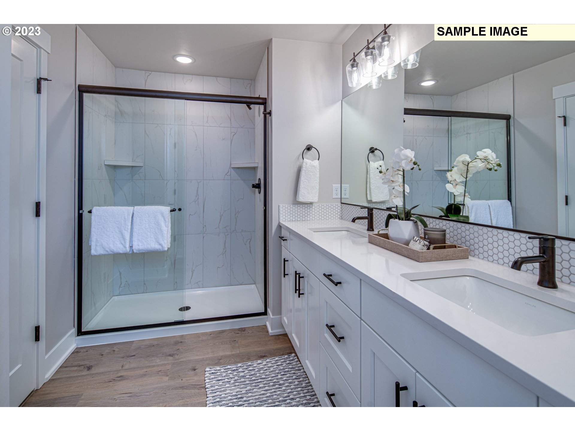 3624 South Arwana Lane Ridgefield, WA 98642 - Photo 3 of 8 a bathroom with a double vanity sink mirror and shower