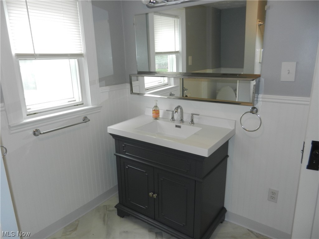 60 East Wilbeth Road Akron, OH 44301 - Photo 15 of 20 Bathroom with new vanity, mirror, and light floors