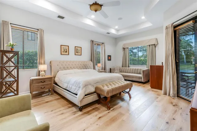 a spacious bedroom with a bed a couch and a window