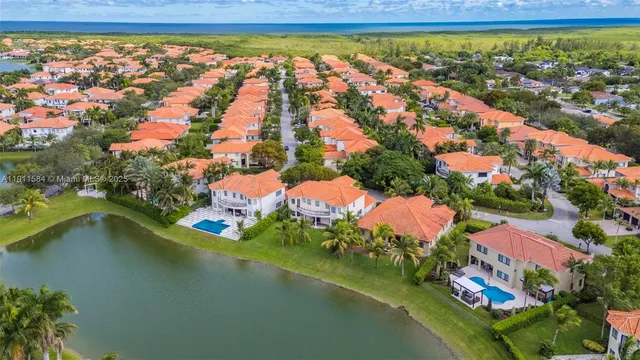 an aerial view of residential houses with outdoor space and swimming pool