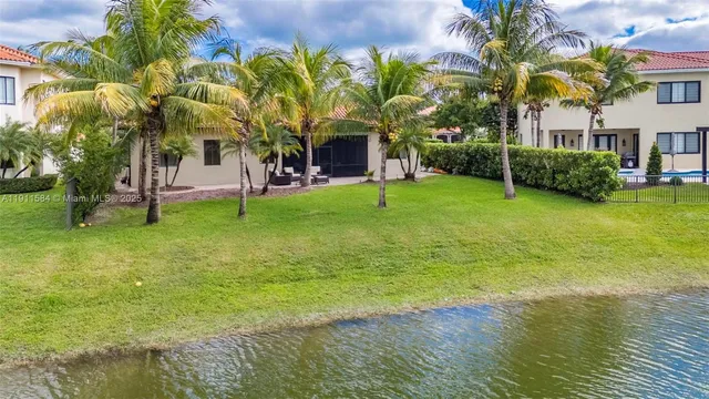 a front view of a house with garden and tree
