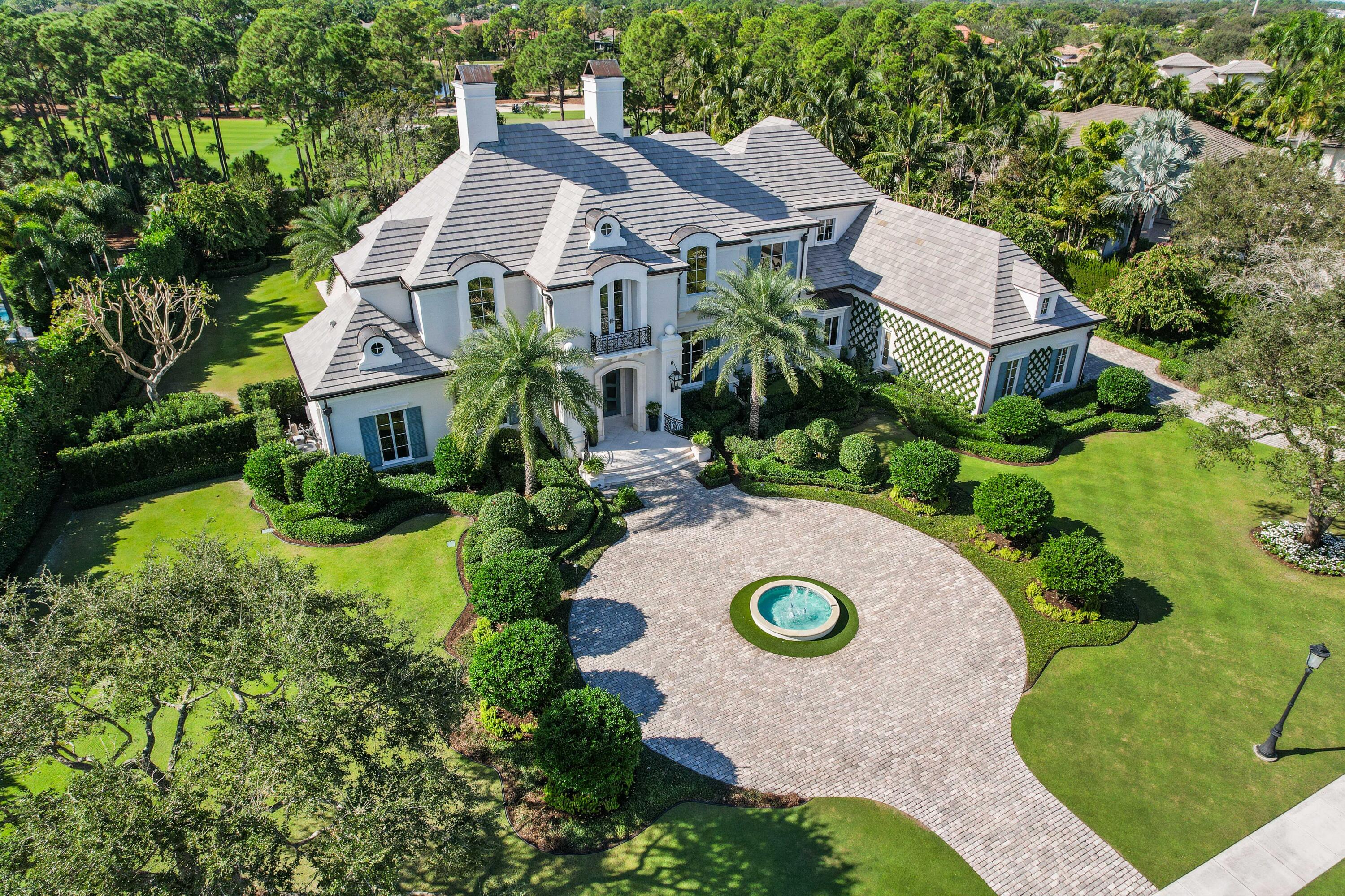 an aerial view of a house with a swimming pool and garden