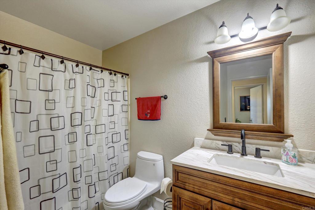 108 Blue Ash Court Encinitas, CA 92024 - Photo 13 of 35 a bathroom with a sink toilet and shower
