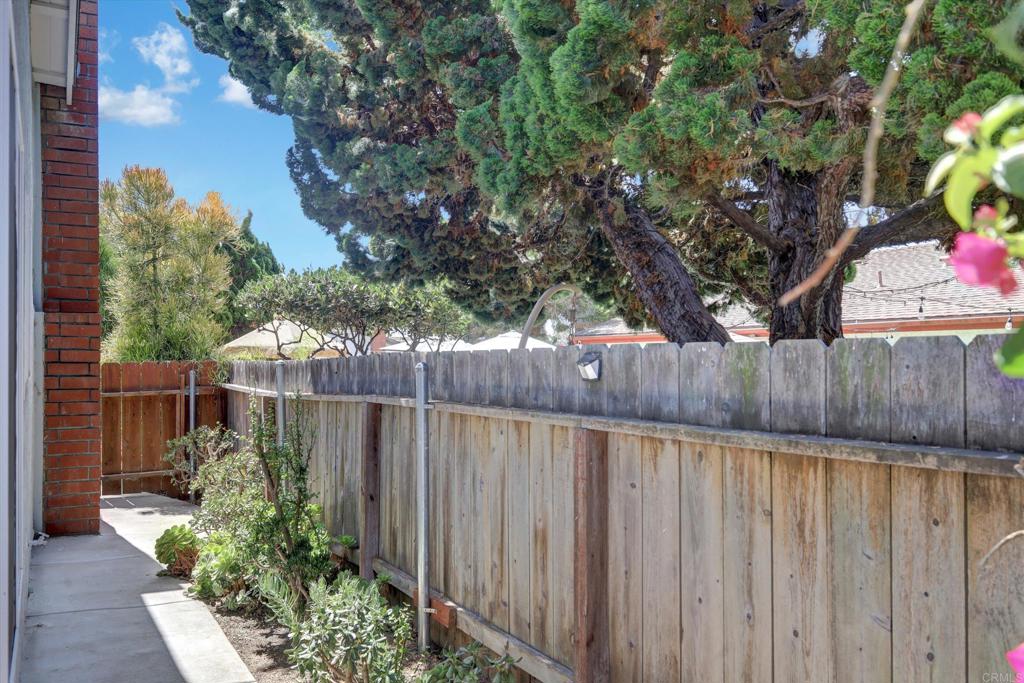108 Blue Ash Court Encinitas, CA 92024 - Photo 28 of 35 a view of a backyard with plants and wooden fence
