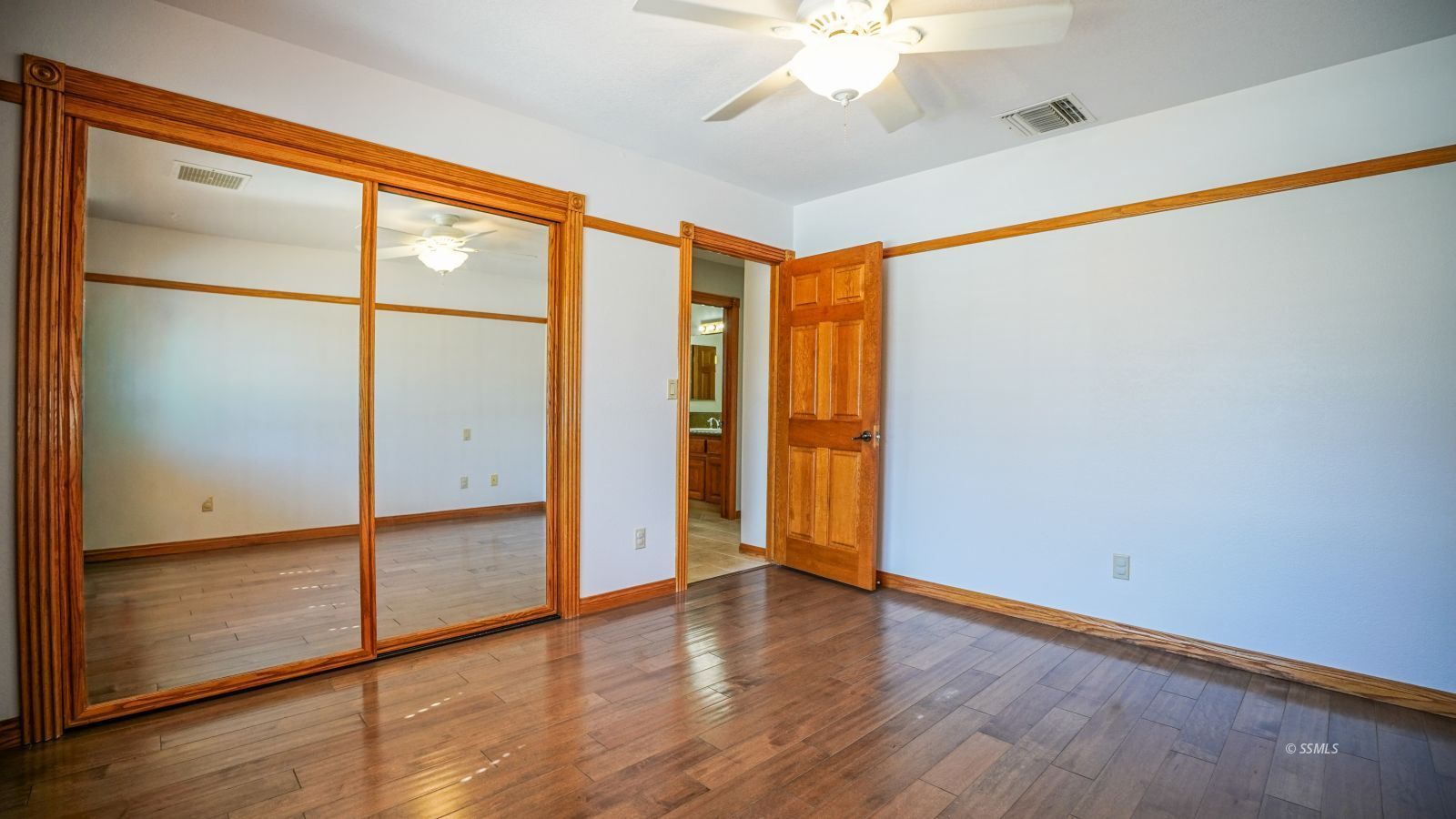 948 Hermosa Avenue Ridgecrest, CA 93555 - Photo 29 of 46 a view of an empty room with wooden floor and a window