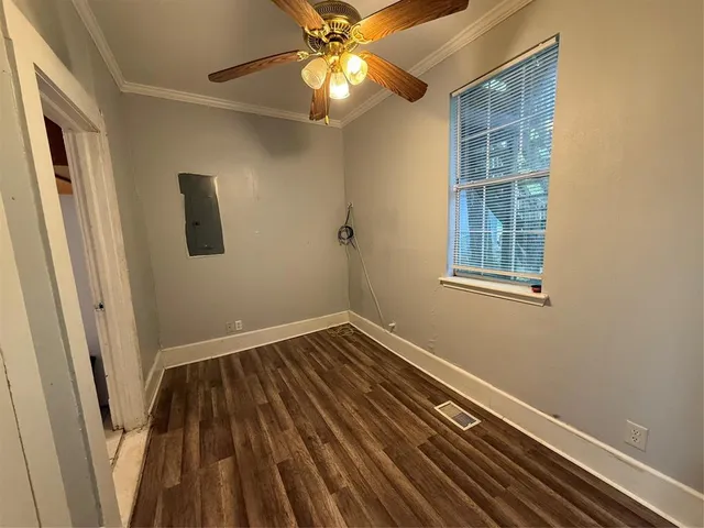 a view of empty room with wooden floor