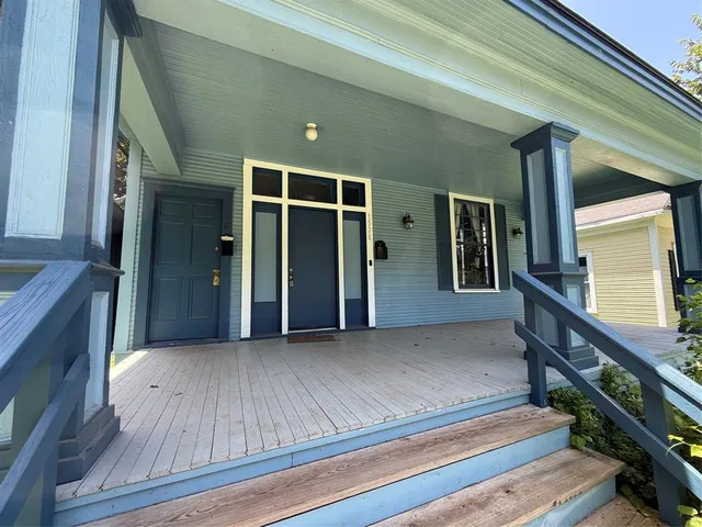 a view of an entryway with wooden floor and stairs