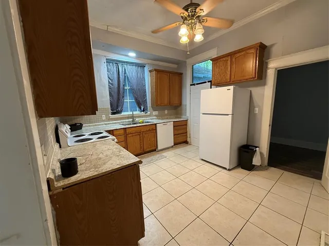 a kitchen with a refrigerator sink stove and cabinets