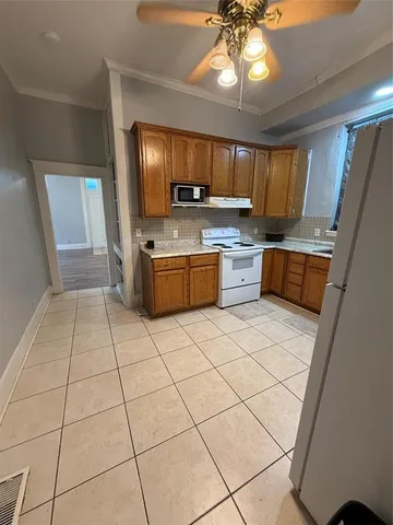 a kitchen with stainless steel appliances granite countertop a sink and a refrigerator