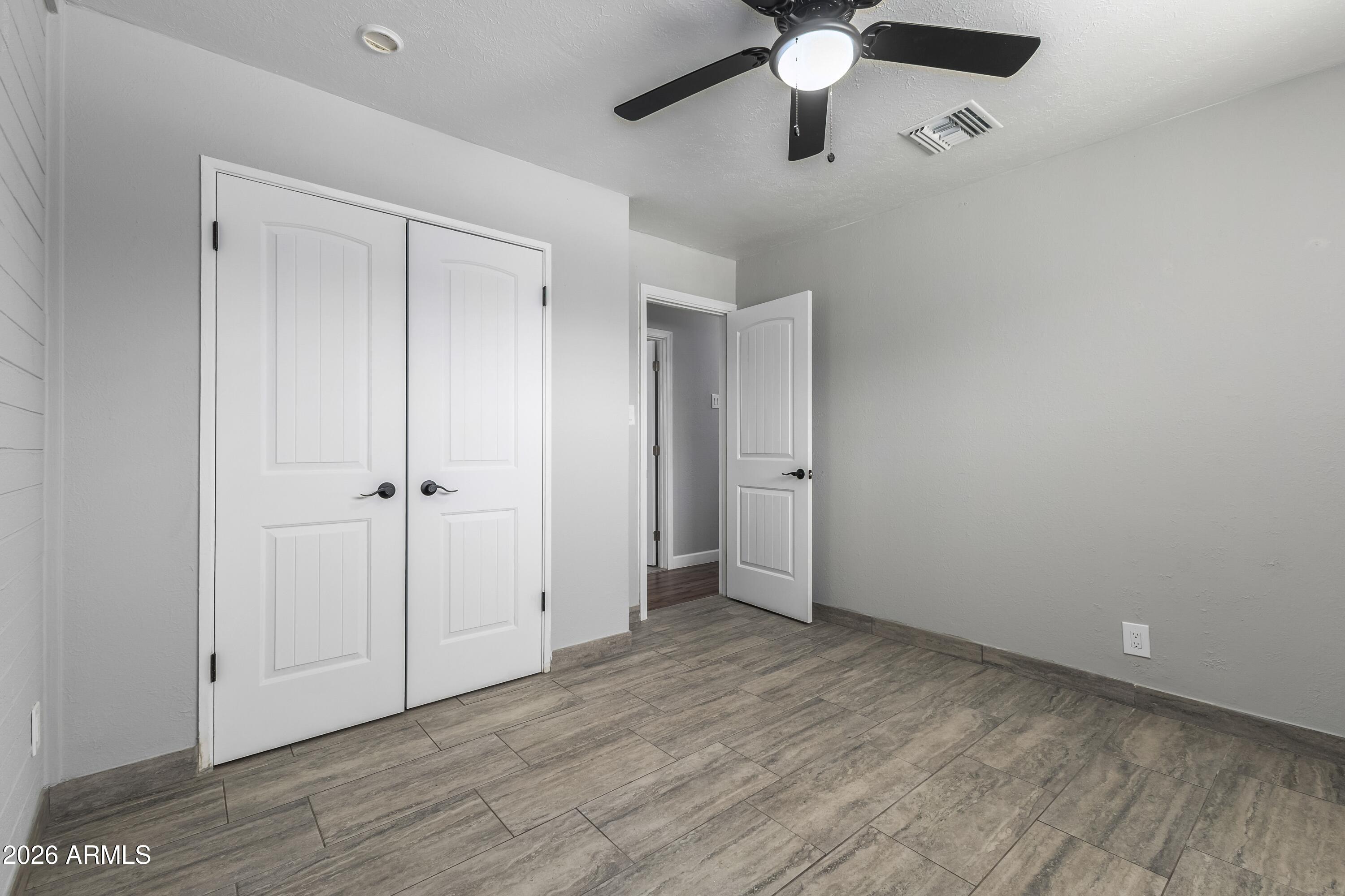 3137 North 37th Drive Phoenix, AZ 85019 - Photo 13 of 18 wooden floor in an empty room