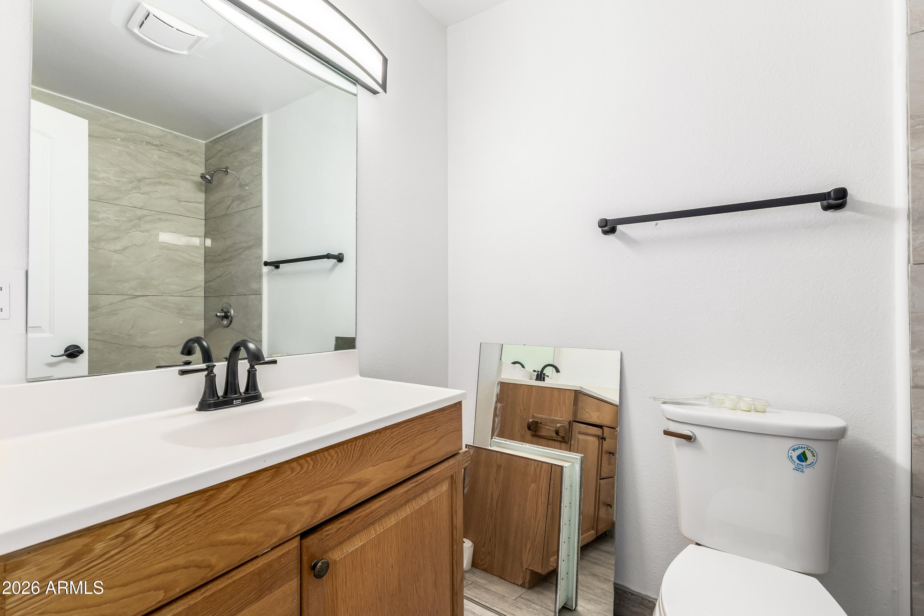 3137 North 37th Drive Phoenix, AZ 85019 - Photo 14 of 18 a bathroom with a sink a toilet and shower