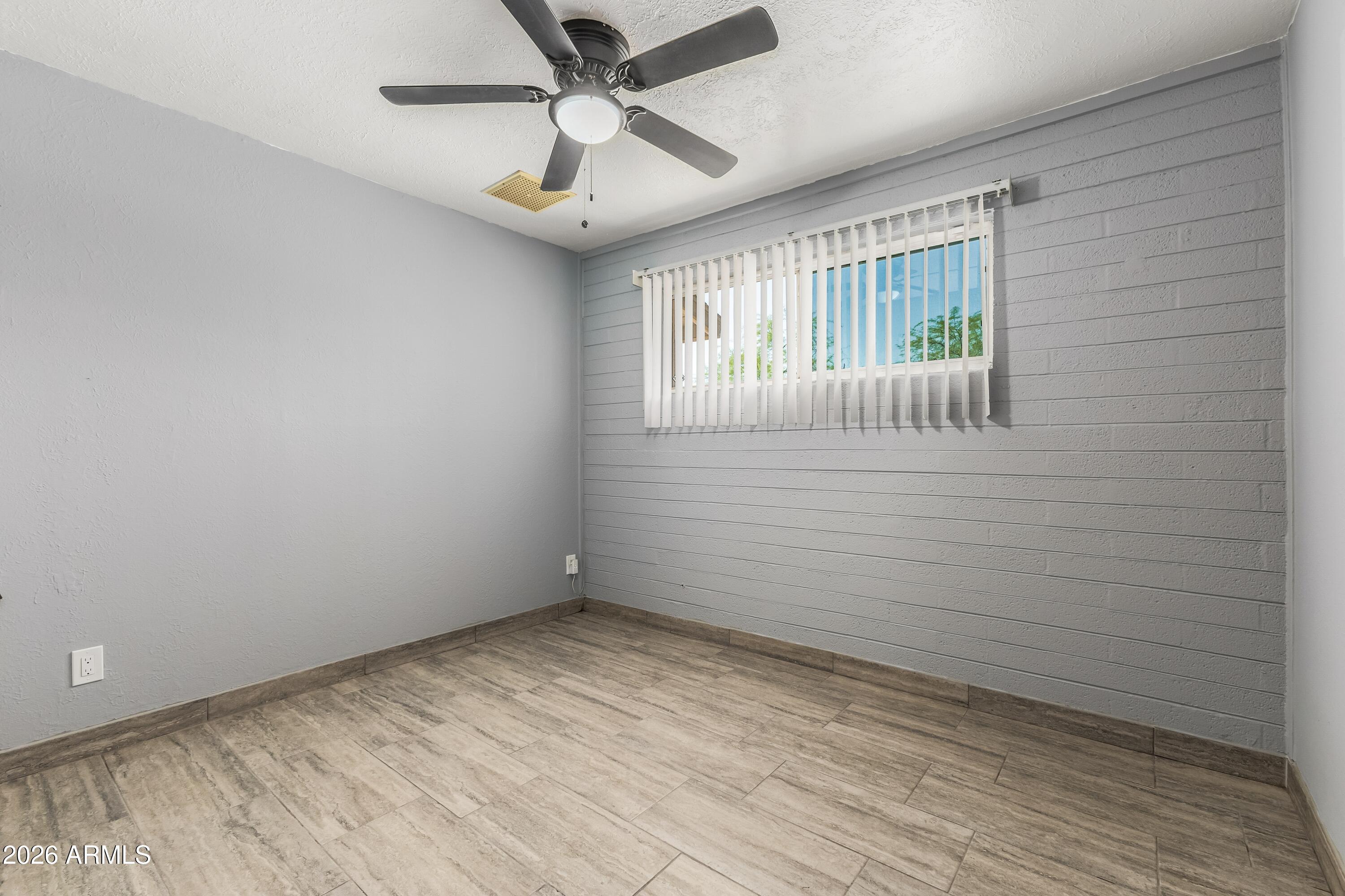 3137 North 37th Drive Phoenix, AZ 85019 - Photo 10 of 18 a view of an empty room with a window