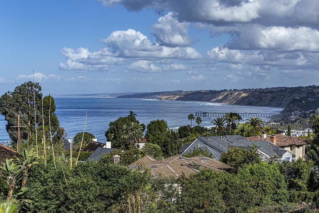 7687 Hillside Drive La Jolla, CA 92037 - Photo 3 of 16 a view of a bunch of flowers in front of house