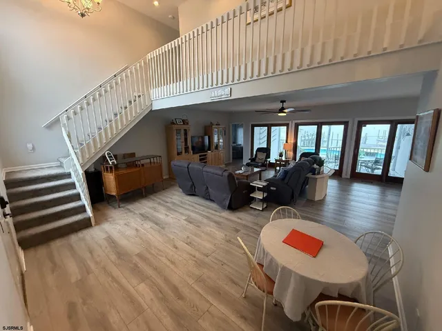 a living room with furniture gym equipment and a large window