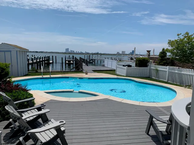 a view of a swimming pool with a lounge chair