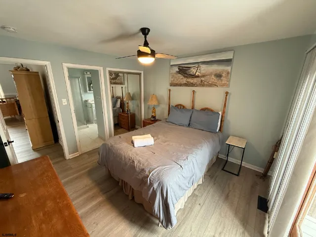 a bedroom with a bed and a large mirror