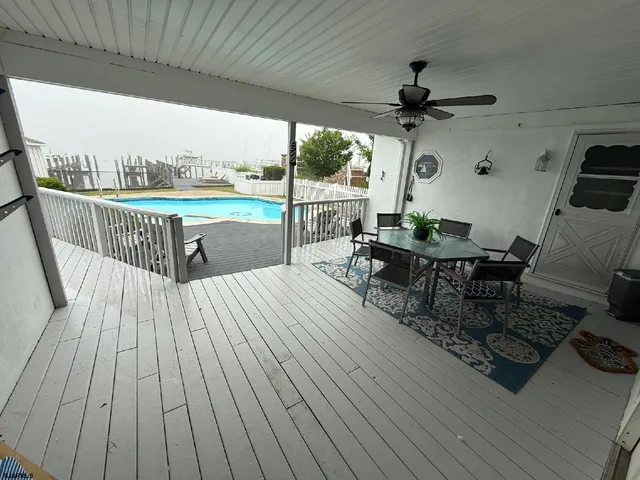 a view of a deck with wooden floor and outdoor seating