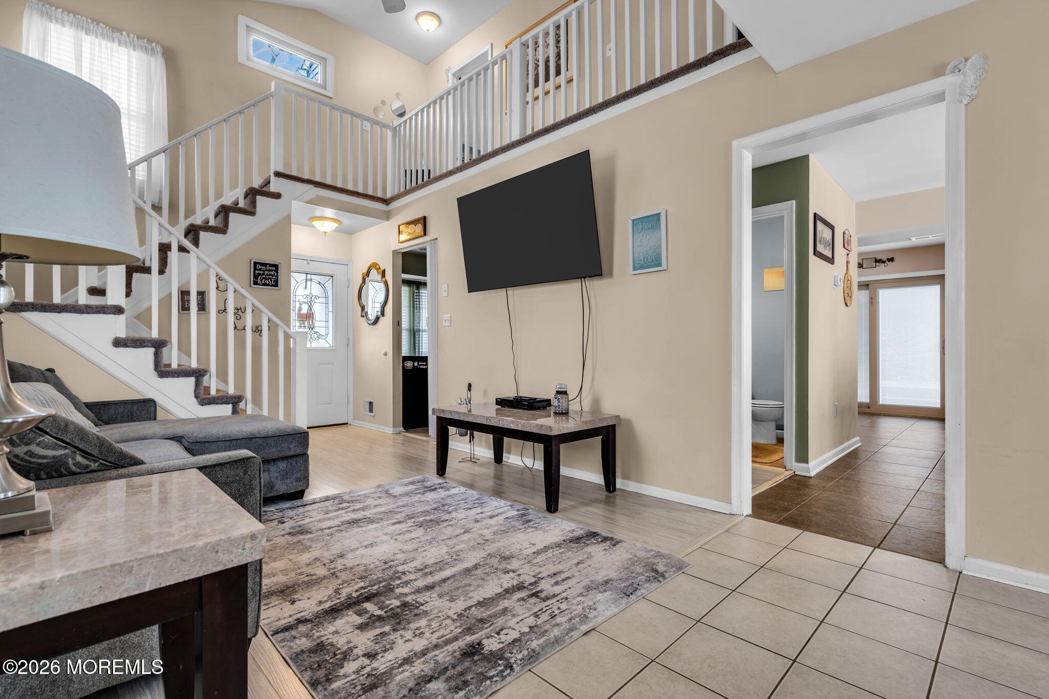 41 Concord Circle Howell, NJ 07731 - Photo 11 of 36 a living room with furniture a flat screen tv and a dining table