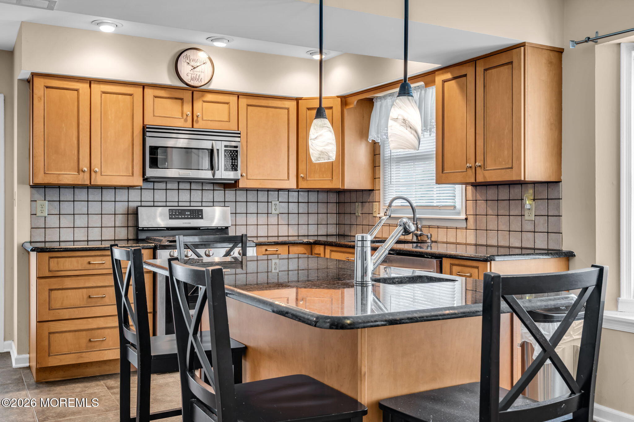 41 Concord Circle Howell, NJ 07731 - Photo 15 of 36 a kitchen with stainless steel appliances granite countertop a sink a stove a table and chairs