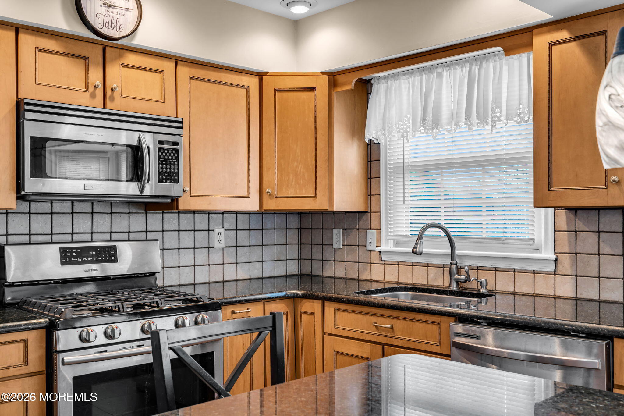 41 Concord Circle Howell, NJ 07731 - Photo 20 of 36 a kitchen with granite countertop a stove a sink and a microwave