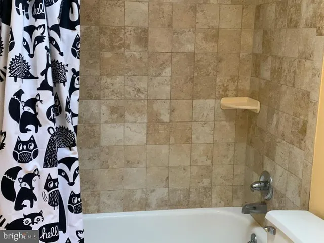 a bathroom with a bathtub and shower