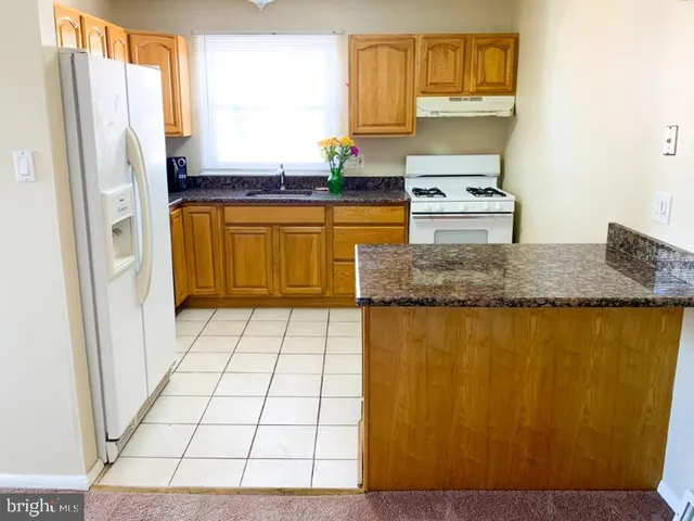 a kitchen with stainless steel appliances cabinets and a counter top space