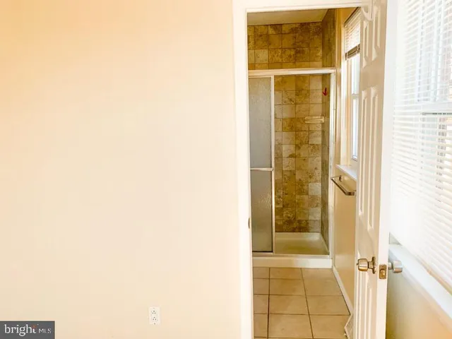 a bathroom with a shower and a door