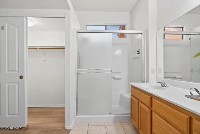 a bathroom with a shower sink and mirror