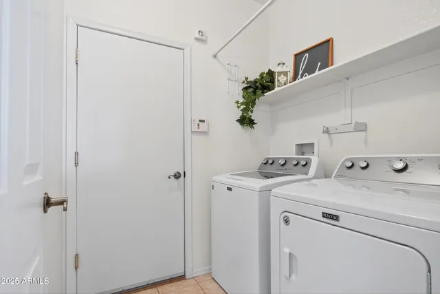 a view of storage and utility room with washer and dryer
