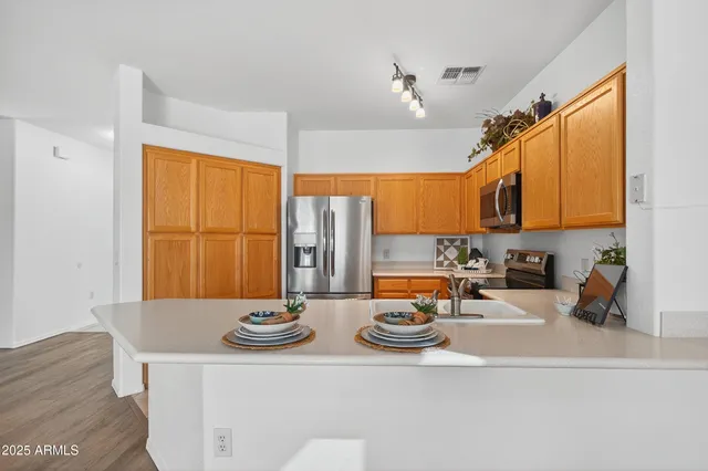 a view of a kitchen with a sink and cabinets