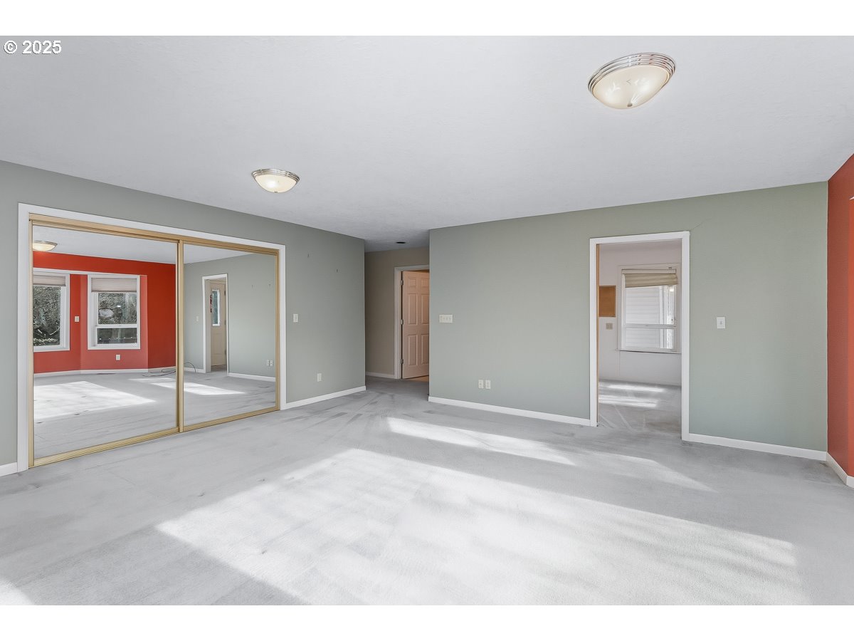 23990 Southwest Tile Flat Road Hillsboro, OR 97123 - Photo 13 of 46 a view of an empty room with window and a kitchen