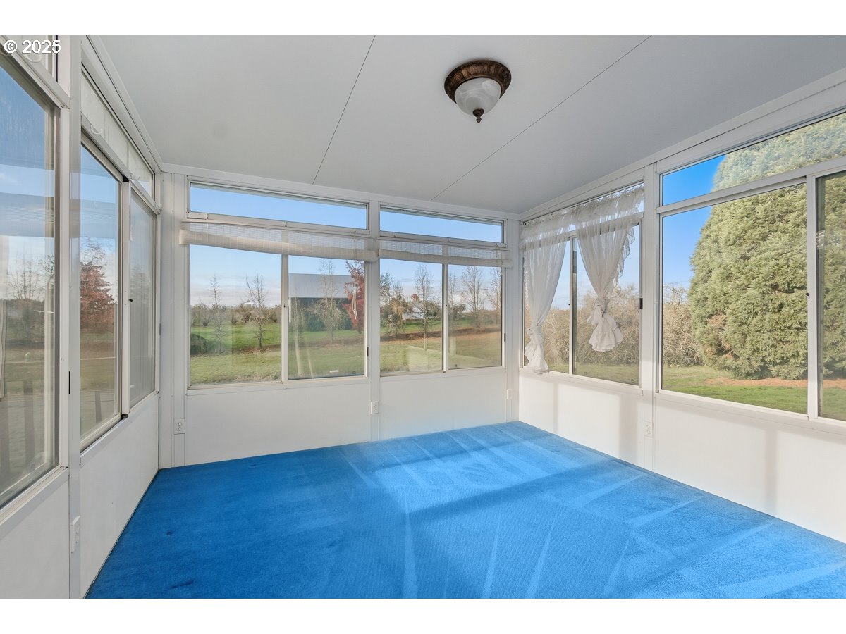23990 Southwest Tile Flat Road Hillsboro, OR 97123 - Photo 17 of 46 a view of an empty room with wooden floor and a window