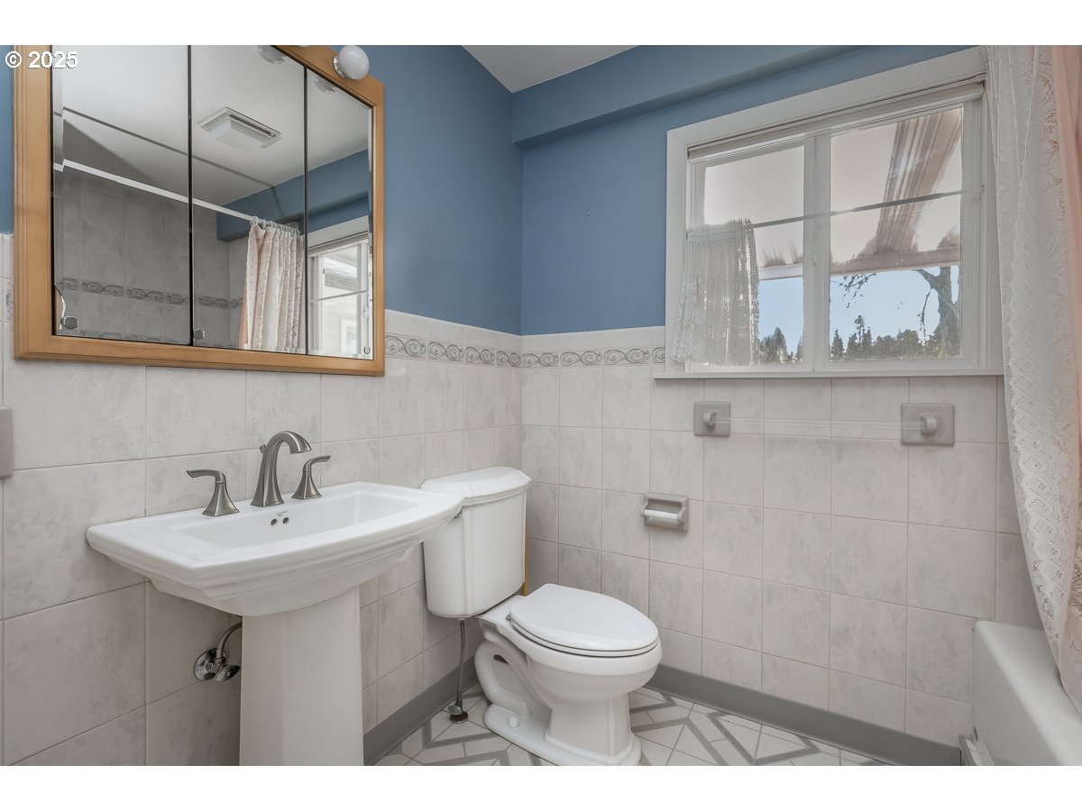23990 Southwest Tile Flat Road Hillsboro, OR 97123 - Photo 20 of 46 a bathroom with a sink a toilet and mirror
