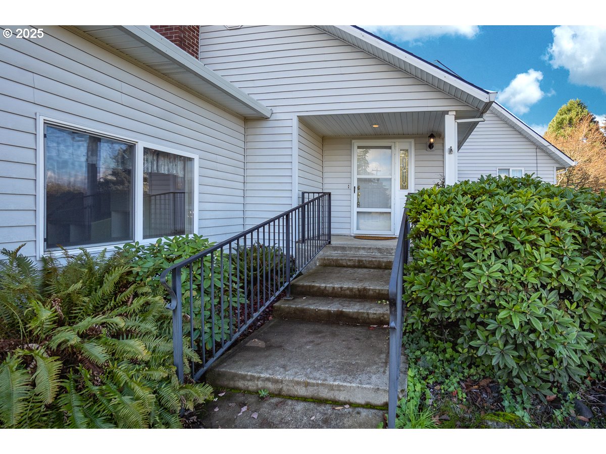 23990 Southwest Tile Flat Road Hillsboro, OR 97123 - Photo 3 of 46 a view of a house with a flower garden