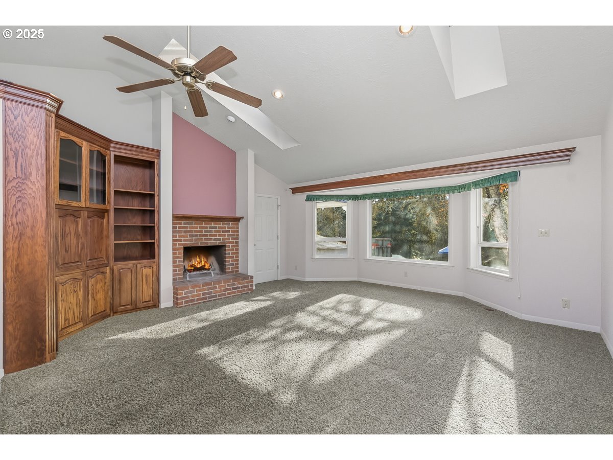 23990 Southwest Tile Flat Road Hillsboro, OR 97123 - Photo 4 of 46 a view of an empty room with a fireplace and a window