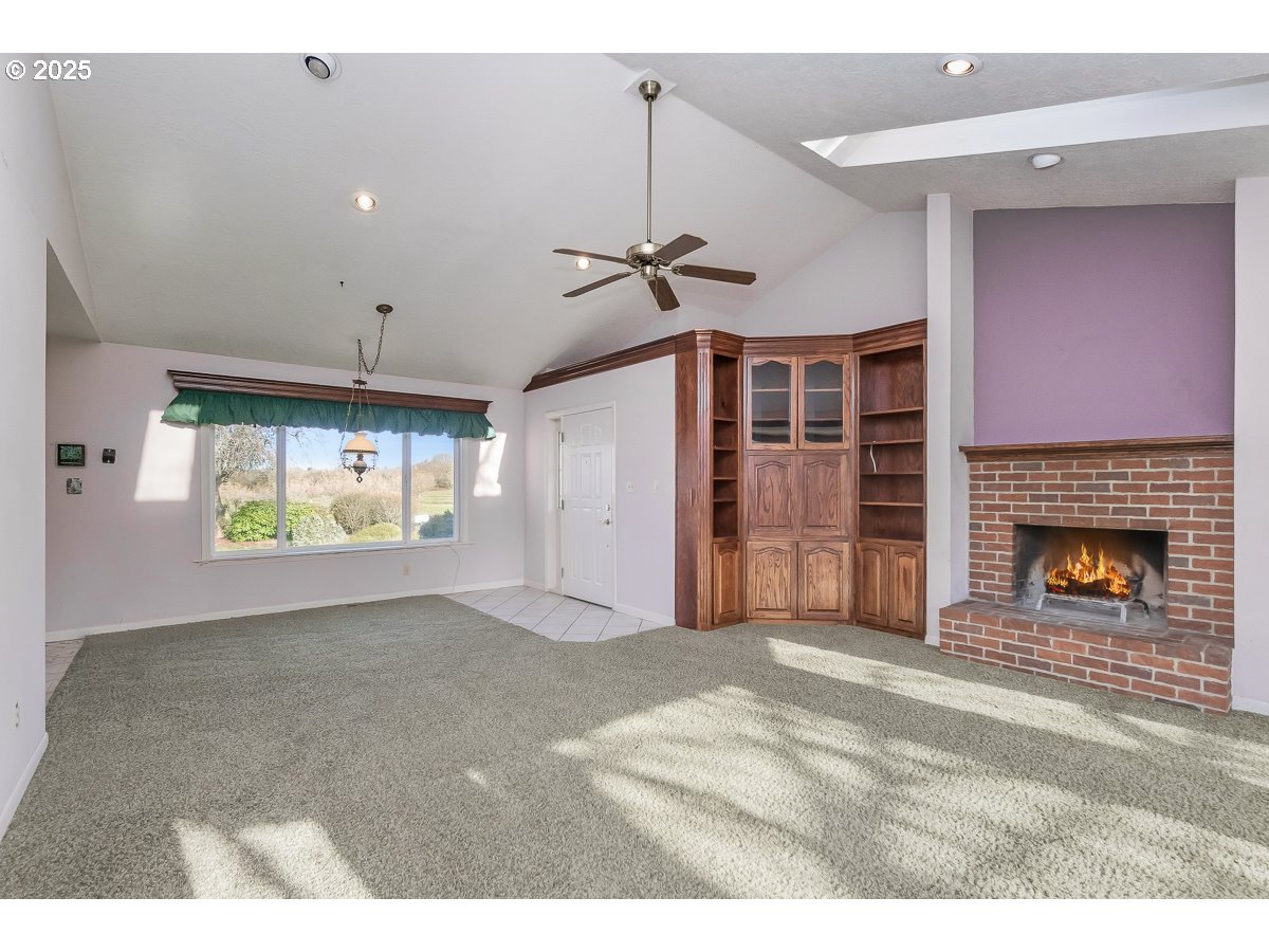 23990 Southwest Tile Flat Road Hillsboro, OR 97123 - Photo 5 of 46 a view of livingroom with fireplace and window