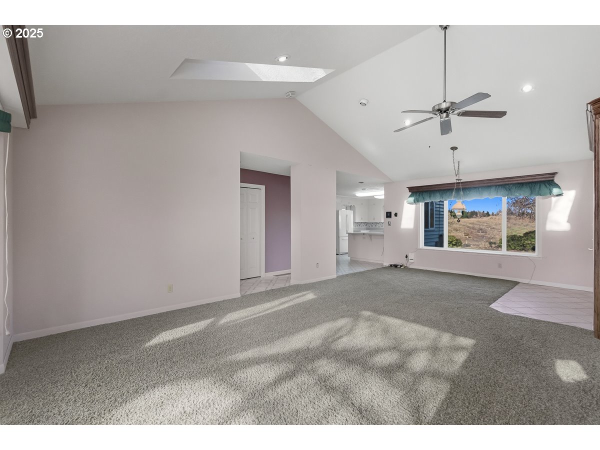 23990 Southwest Tile Flat Road Hillsboro, OR 97123 - Photo 6 of 46 a view of empty room with a ceiling fan and window